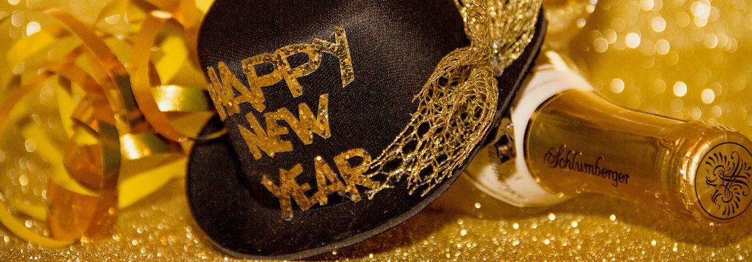 Happy New Year Hat and Champagne Bottle on Gold Background
