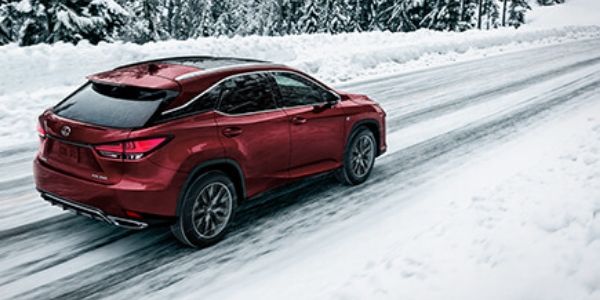 Red 2020 Lexus RX with AWD Driving on a Snowy Road