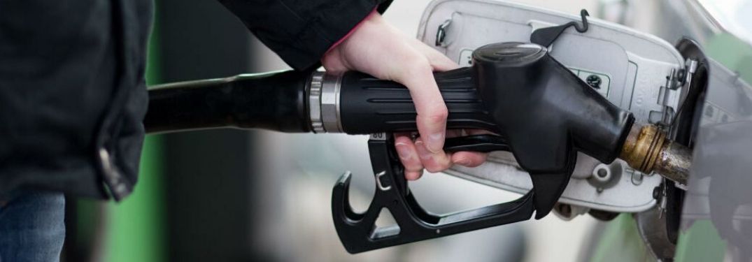 Person Filling a Car at the Fuel Pump