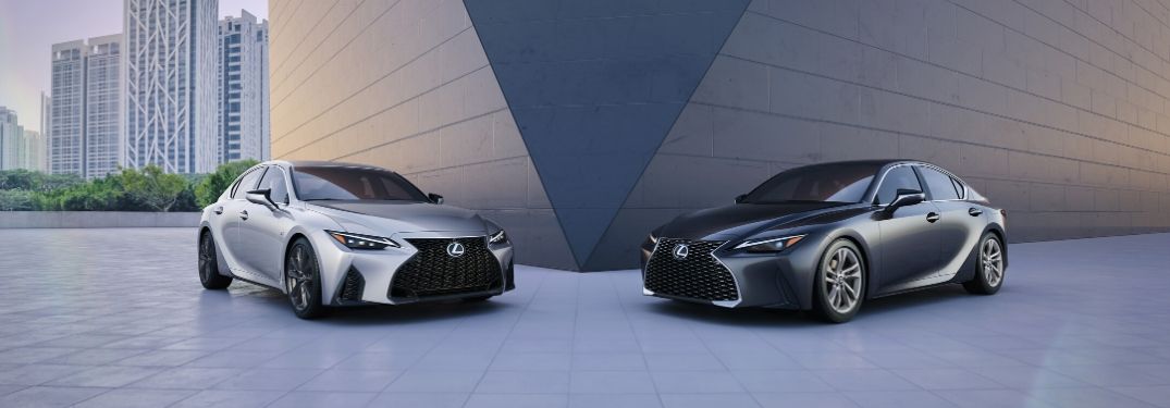 Silver and Gray 2021 Lexus IS Models Next to a Modern Building