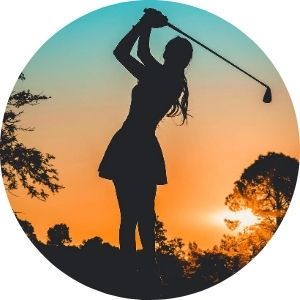 Silhouette of Woman Playing Golf at Sunset