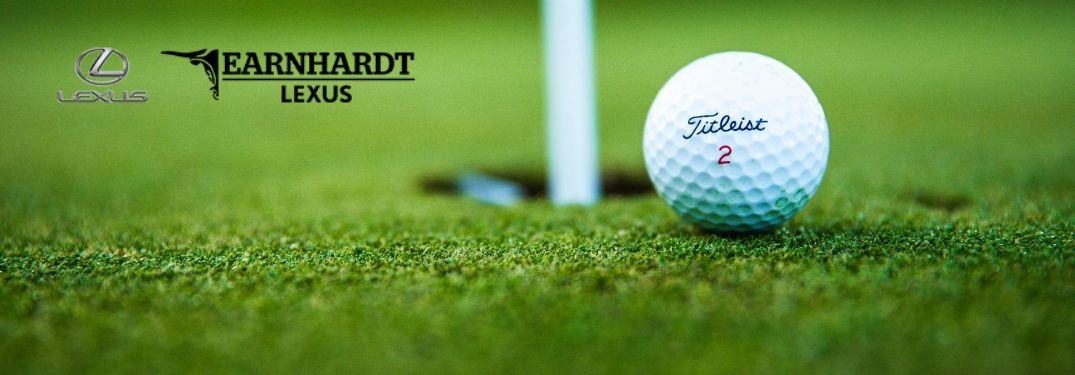 Close Up of Titleist Golf Ball Next to a Hole with Earnhardt Lexus Logo in Upper Left Corner