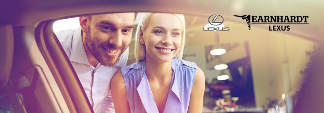 Couple Looking in a New Car with Earnhardt Lexus Logo in Upper Right