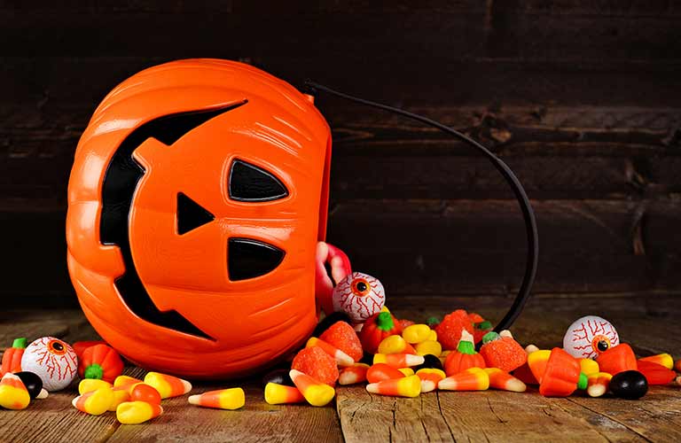 Tipped Over Halloween Pumpkin Bucket with Candy