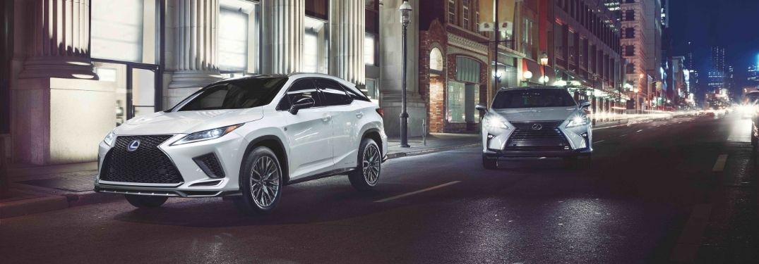 White and Silver 2021 Lexus RX Models on a City Street at Night