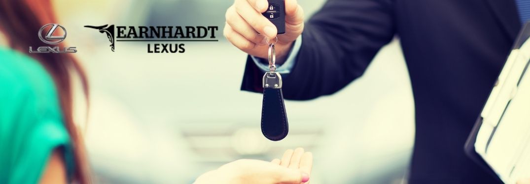 Car Dealer Handing Keys to a Woman with Earnhardt Lexus Logo
