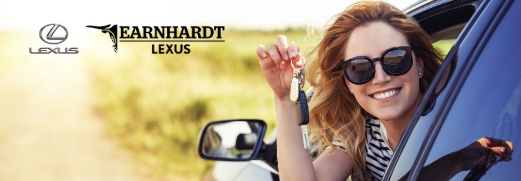 Happy Woman in Car Smiling with Car Keys and Earnhardt Lexus Logo
