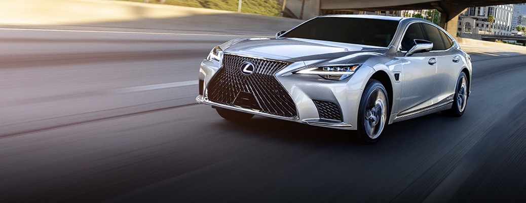A new Lexus driving on the freeway.
