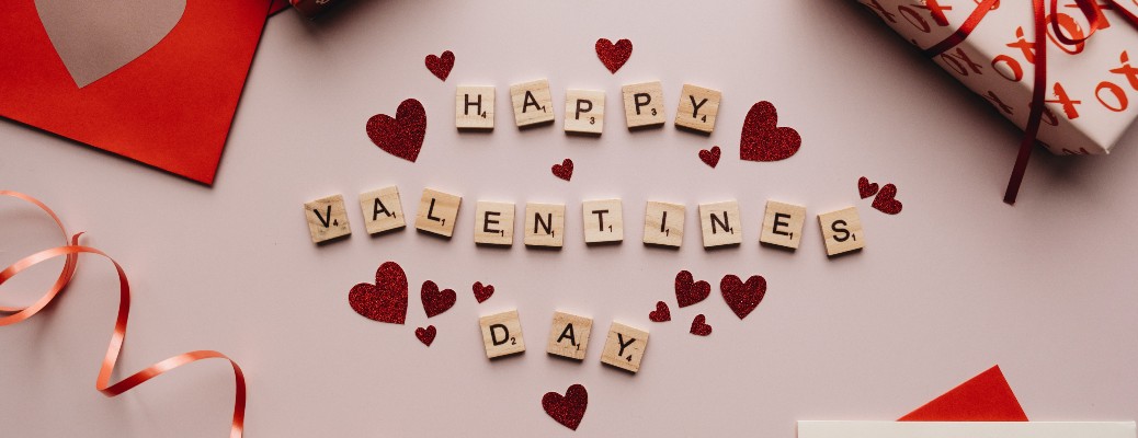 Scrabble letters with red hearts interspersed spelling out Happy Valentine's Day, regarding What to Do in Phoenix Arizona for Valentine’s Day 2022