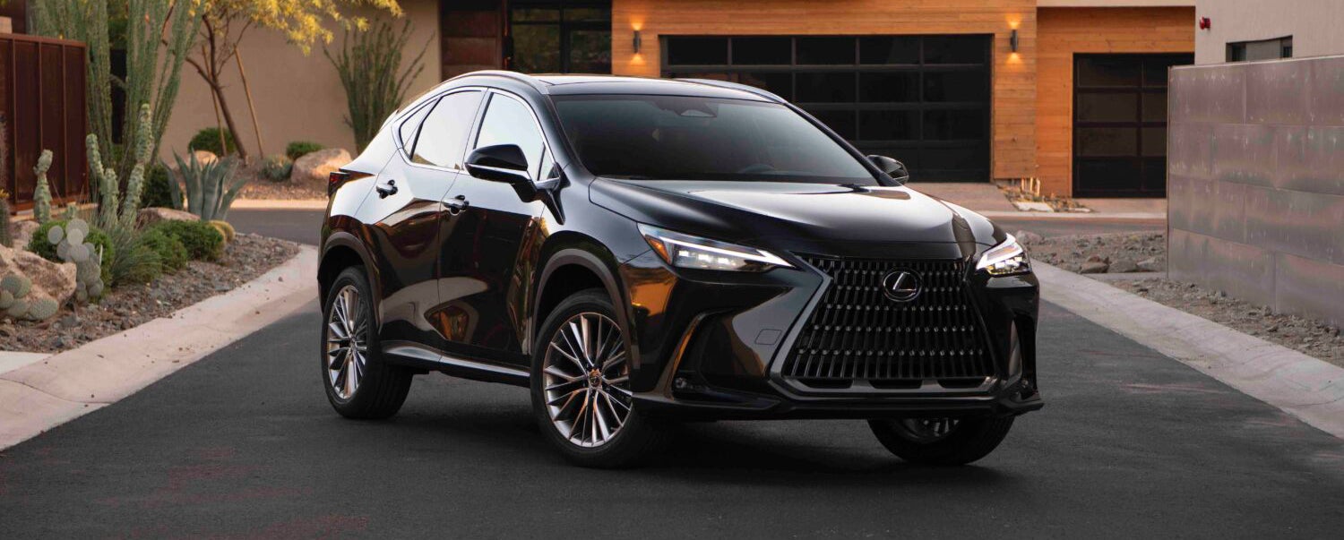 Black Lexus NX 350h parked in a modern driveway.