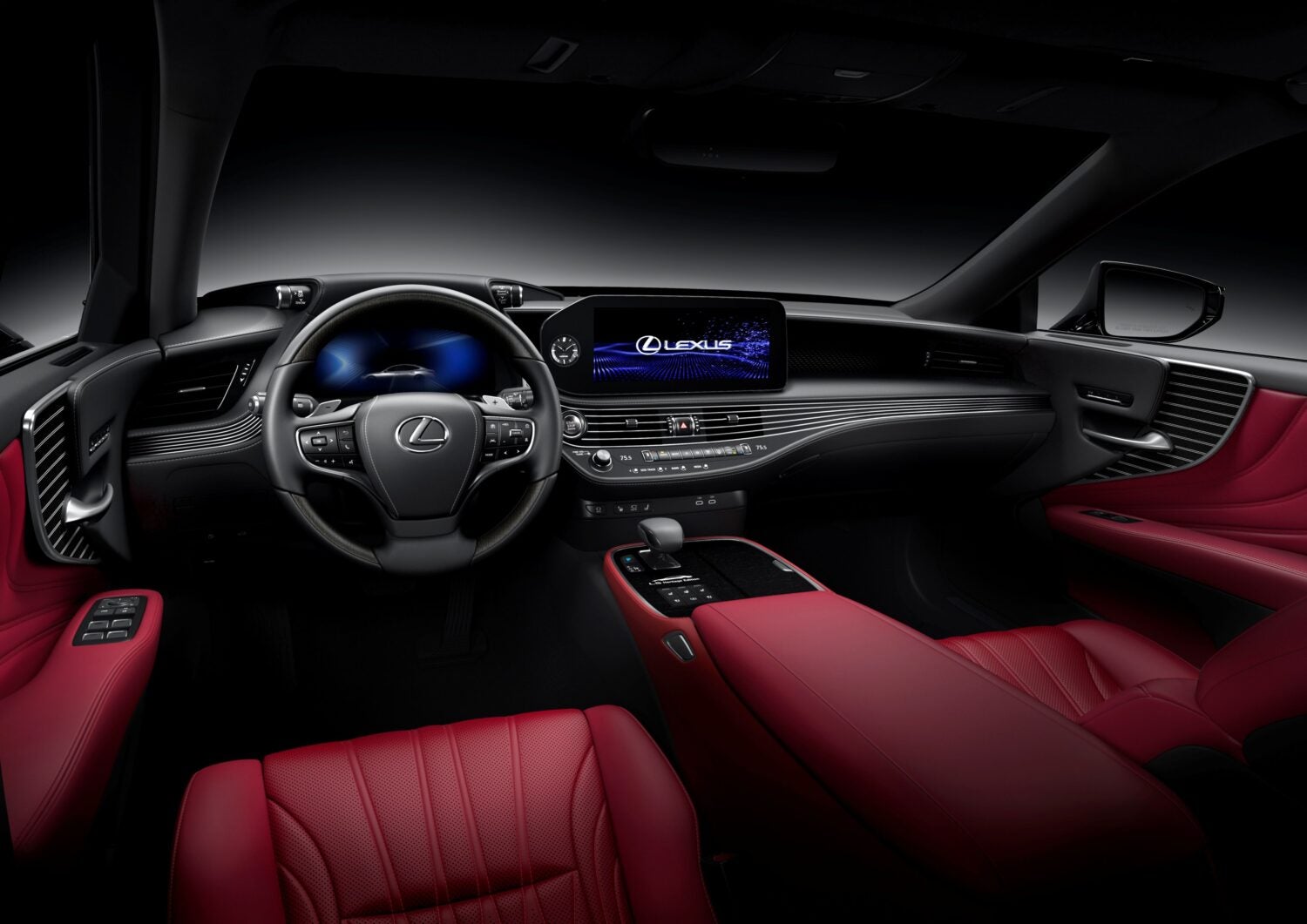 The modern red and black interior of the new Lexus LS in Phoenix is seen through a wide lens from above the driver's seat.